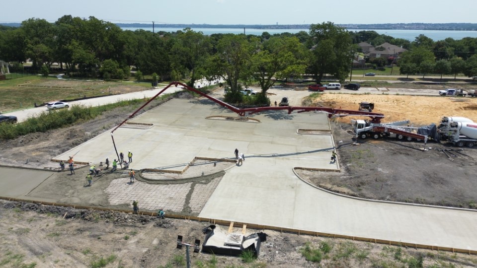 Aerial concrete pour by the lake — TRX Construction