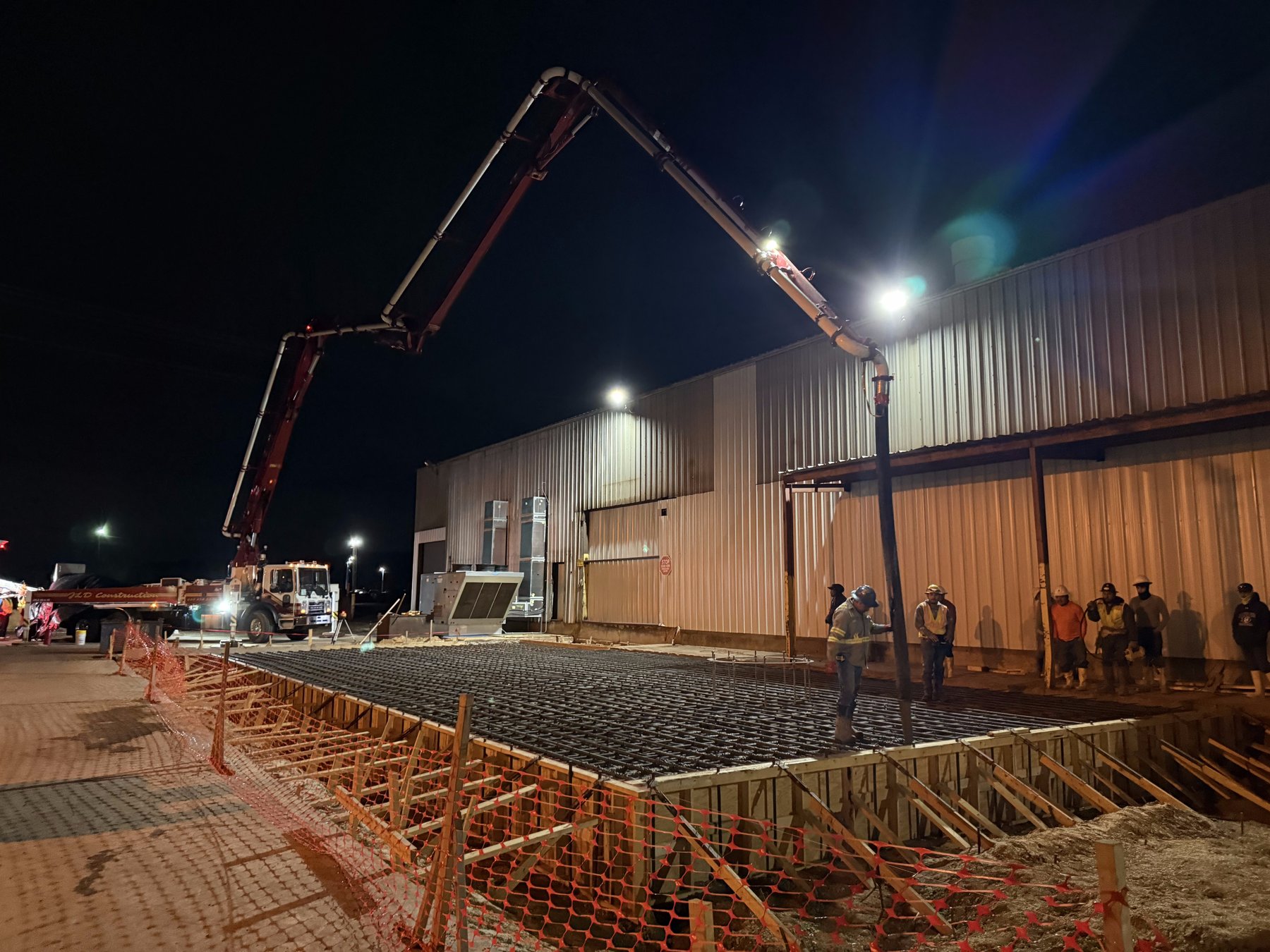 Night pump truck pour with floodlights — TRX Construction