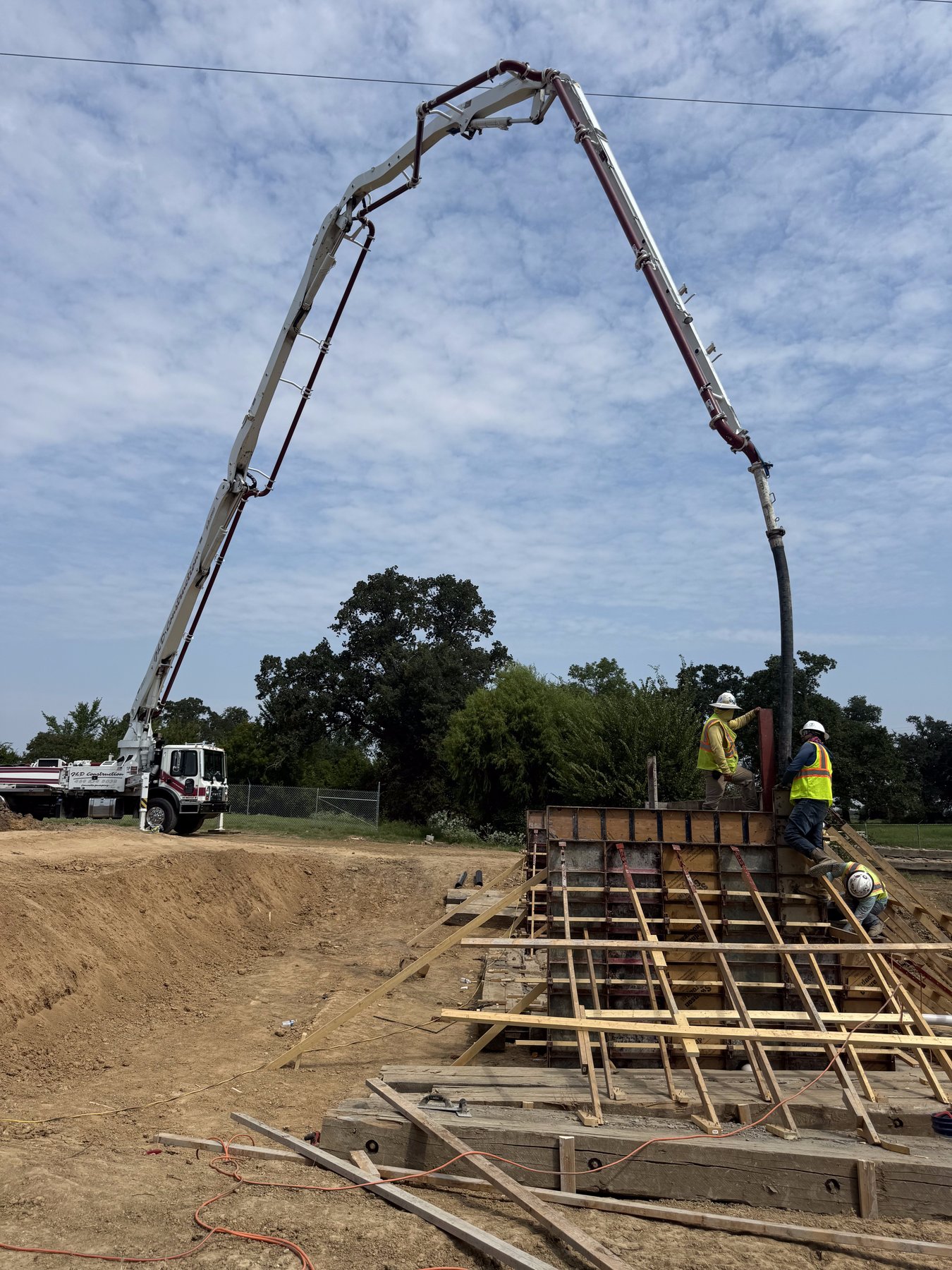 Concrete pump truck boom extended — TRX Construction